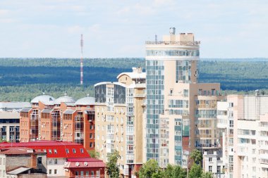 Bulunan orman ile güneşli günde büyük şehrin modern binalar 