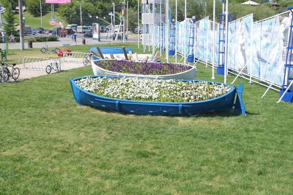 PERM, RUSSIA - JUN 11, 2013: Flowerbeds of river ship at entranc