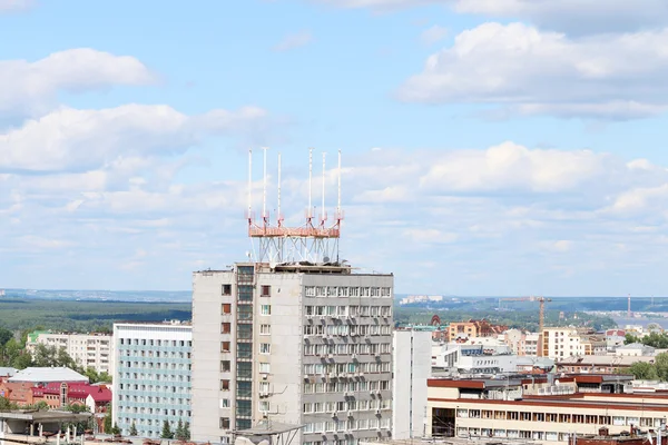 Modern apartment buildings in big city on sunny day with forest — Stock Photo, Image