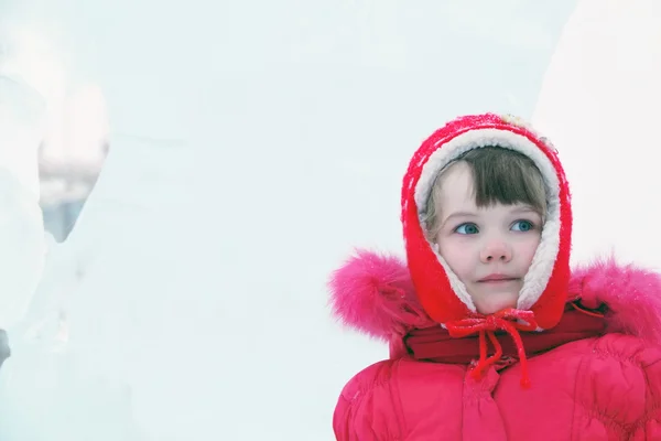 Kleines glückliches Mädchen in roter warmer Kleidung schaut am Wintertag weg — Stockfoto