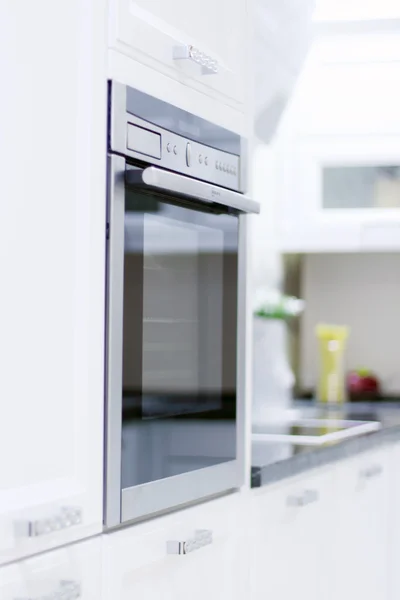 Built-in oven in new modern kitchen with white wooden furniture — Stock Photo, Image
