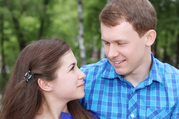 Happy man and woman look at each other in green park at summer d — Stock Photo, Image