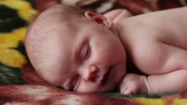 Weinig schattige baby slaapt en glimlacht op pluizig deken — Stockvideo