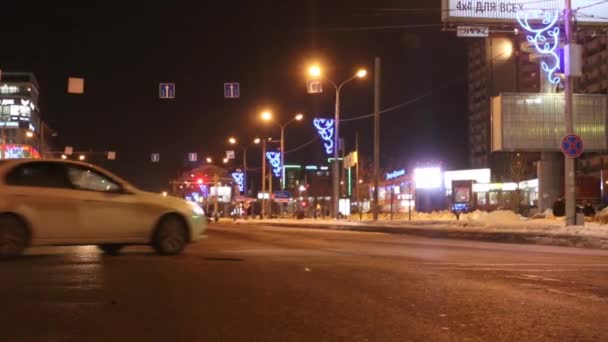 PERM, RUSSIA - FEB 27, 2015: (variable depth of field) Cars move on street at winter night. In Perm region of about 1 million cars — Stock Video