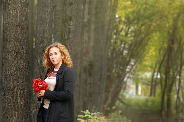 Krásná žena s červenými jeřabinovo stojany — Stock fotografie