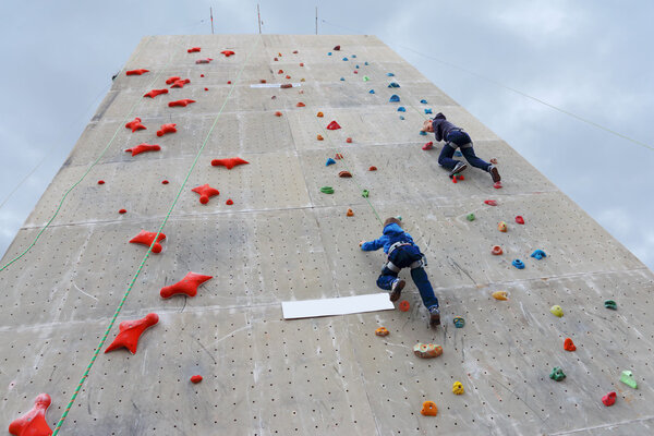 PERM, RUSSIA - JUN 15, 2014: Boys climbing with rope