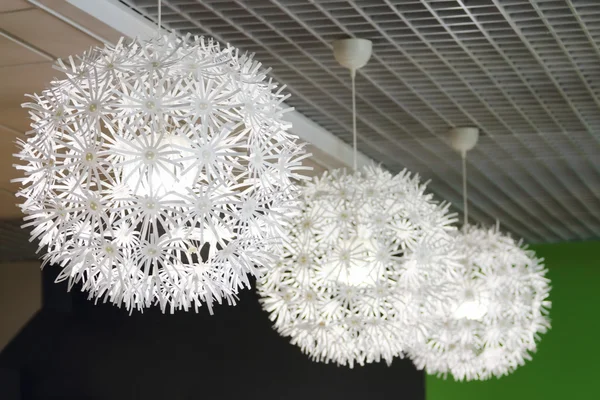 Três lâmpadas incomuns modernas com tons brancos no teto no quarto — Fotografia de Stock