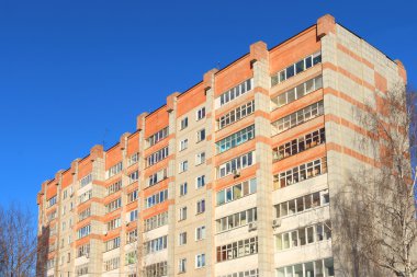 Top of high residential building with balconies and trees