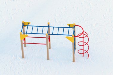Top view of empty children playground covered by snow