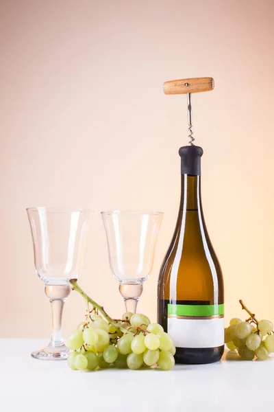 Bottle of white wine and a corkscrew for wine — Stock Photo, Image