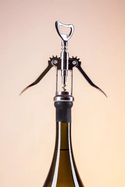 Bottle of white wine and a corkscrew for wine — Stock Photo, Image