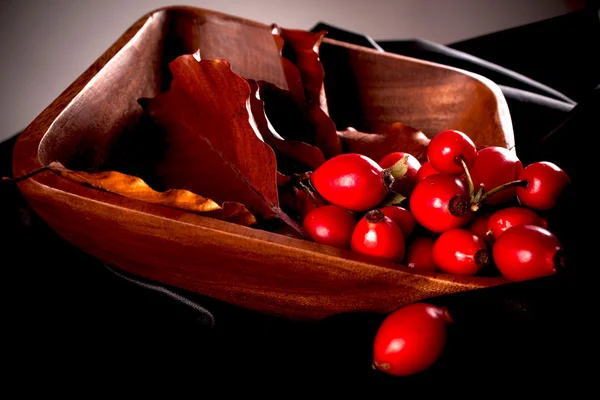 Dogrose with leafs over Wooden Background — Stock Photo, Image