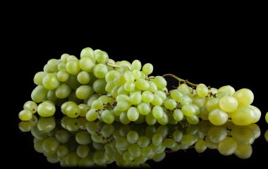 White grapes on a black background clipart