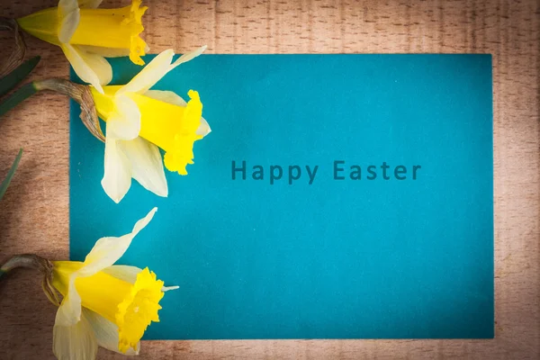 Easter card with an inscription on a wooden background — Stock Photo, Image