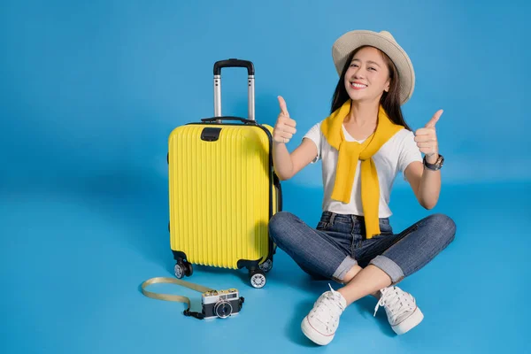 Happy Young Asian Woman Traveler Sitting Yellow Suitcase Blue Background — Stock Photo, Image