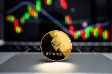 Ethereum altın madeni para bilgisayar ekranında grafik arkaplanı olan bir dizüstü bilgisayara yerleştirilir.