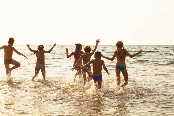 A group of young people dancing on the ocean