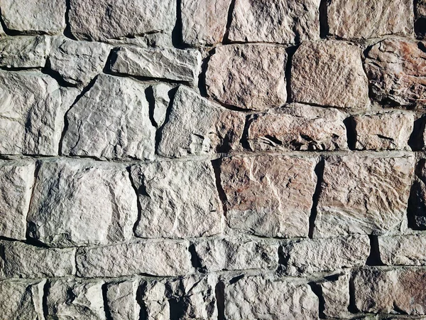 Masonry stone wall texture. Stones in the foundation. Stone wall background for design or illustration