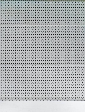 gray metal background with a pattern and a white shelf