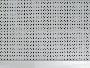 gray metal background with a pattern and a white shelf