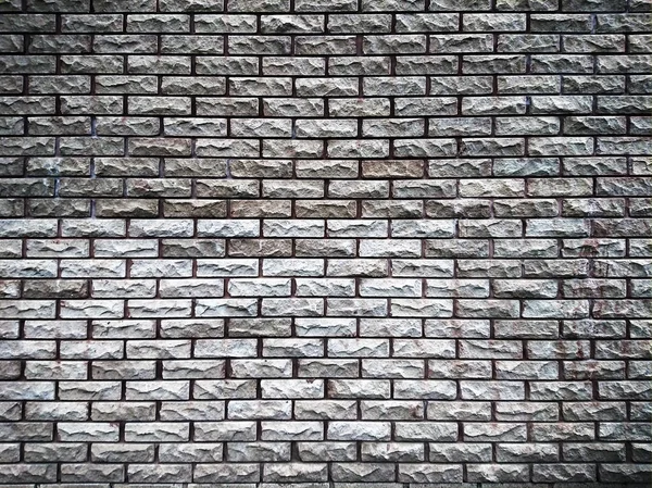 Covering the wall surface with imitation bricks of gray and brown colors —  Fotos de Stock