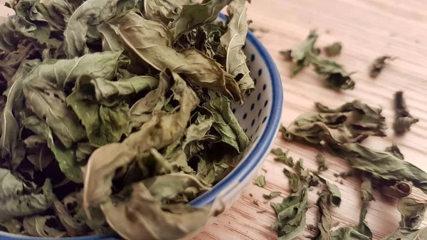 These dried mint leaves are ready to be used in tea or meal preparation. This image is a close up of the actual mint leaves. The use of mint is great for getting a nice breath and it also tastes amazing in any type of herbal tea.