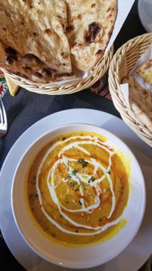 Meyhanede servis edilen bir Hint yemeği baharat, bitki ve soslar gibi geleneksel tatları sıradan bir yemek setiyle birleştiriyor. Sunumda köri, pirinç veya yassı ekmek, kültür mutfağı ve rahat bir bar atmosferi sunulabilir..