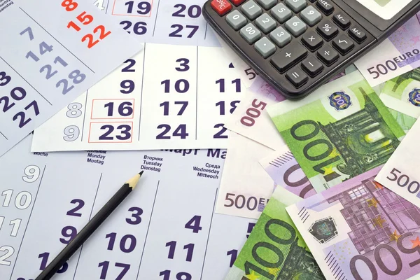 Geld und Taschenrechner im Monatskalender — Stockfoto