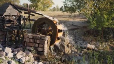An old water mill rotated by the flow of water.