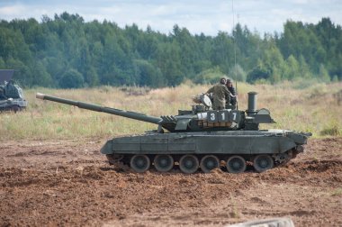 MILITARY GROUND ALABINO, MOSCOW OBLAST, RUSSIA - Aug 24, 2017: Russian gas turbine main battle tank T-80U is on the road at the international military-technical forum ARMY-2017 clipart