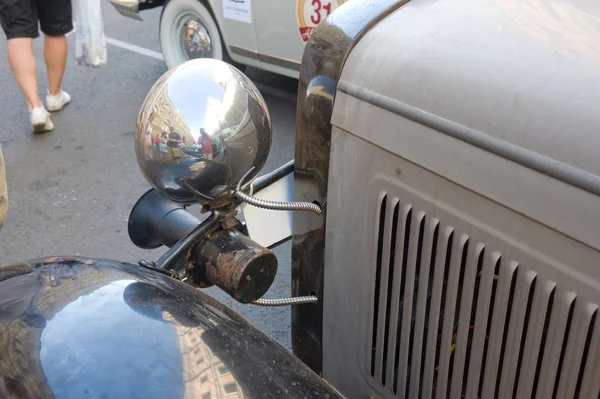 Soviet retro car GAZ-A (licensed copy Ford-A) for retro rally Gorkyclassic in the Parking lot near Gum Department store, Moscow, fragment with headlight