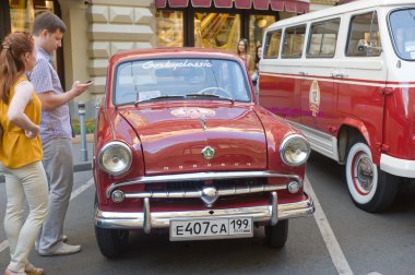 Soviet retro car Moskvich-407 on retro rally Gorkyclassic in the Parking lot near Gum Department store, Moscow, front view clipart