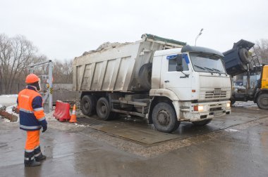 Beyaz damperli kamyon Kamaz ve çalışan Mosvodokanal negotable kar erime noktası, Moskova tarih hakkında