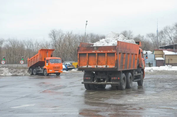 Los camiones llegan a la nieve de descarga en el punto de fusión de nieve Moscú —  Fotos de Stock