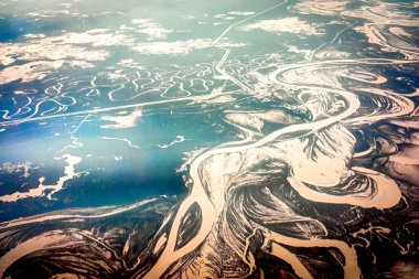 The Aerial view the river on snow-covered forest plain