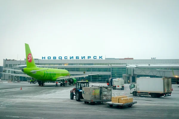 NOVOSIBIRSK, RUSIA - 02 DE MARZO DE 2016: Avión de aerolíneas S7 preparándose para el vuelo en el aeropuerto de Tolmachevo. Aeropuerto es el nudo de tránsito Ural más grande en las principales direcciones entre Europa y Asia . — Foto de Stock