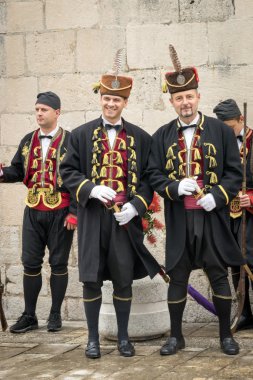 Perast, Montenegro - May 15, 2016: Shooting the Kokot (rooster) celebration. Celebrates the liberation of Perast from Turkish in 1654. Military in traditional historic uniform at the parade.