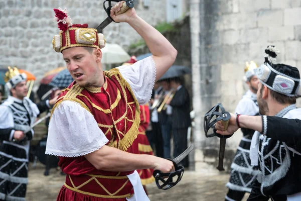 Perast, Montenegro - May 15, 2016: Shooting the Kokot (rooster) celebration. Celebrates the liberation of Perast from Turkish in 1654. Theatrical performance on a city street. Warriors battle. — Stock Photo, Image