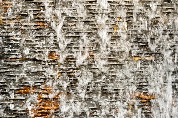 Water fall on dark stone tile wall — Stock Photo, Image