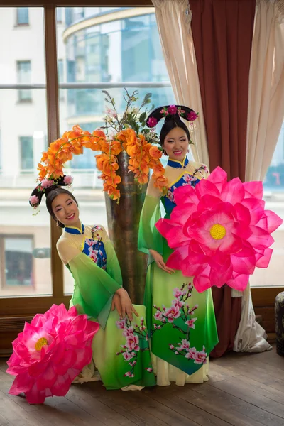 beautiful chinese women in green traditional dresses and floral parasol