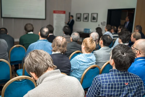 Visão traseira do público em uma sala de conferências durante a apresentação de negócios — Fotografia de Stock