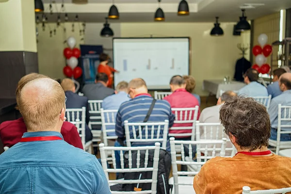 Vue arrière des gens d'affaires qui écoutent attentivement pendant qu'ils sont assis à la conférence — Photo