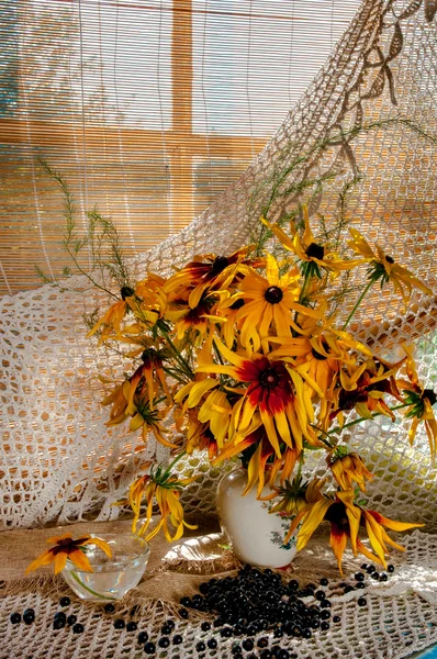 Bouquet of bright yellow flowers on the window sill — Stock Photo, Image