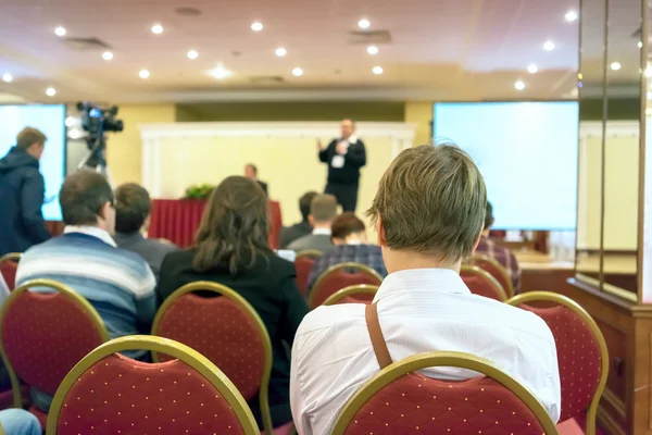 Люди, сидящие сзади на деловой конференции — стоковое фото