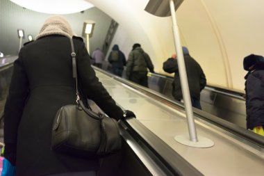 Metro yürüyen merdiven üzerinde insan arkadan görünüş