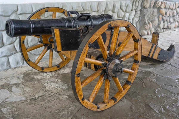 Old medieval artillery canon before a stone wall — Stock Photo, Image