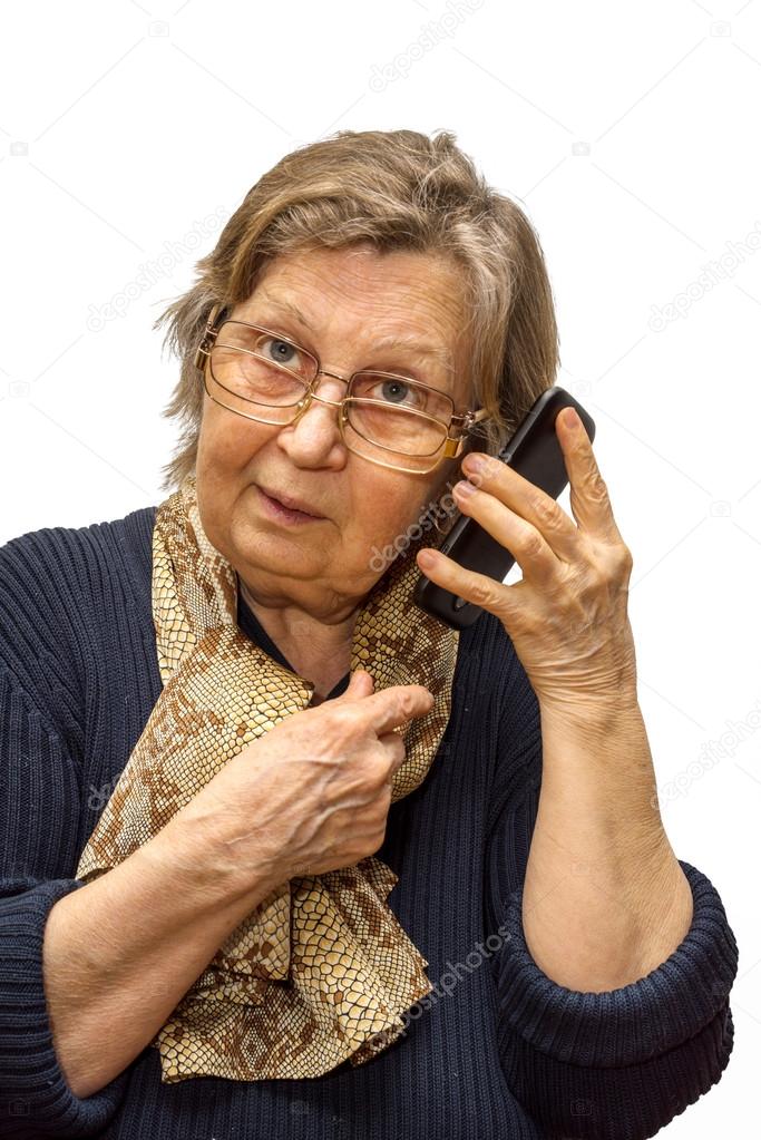 Pensioner woman wearing two pair of glasses calling phone on white - Main Image