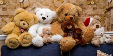 A group of cute teddy bears sitting together on the sofa clipart