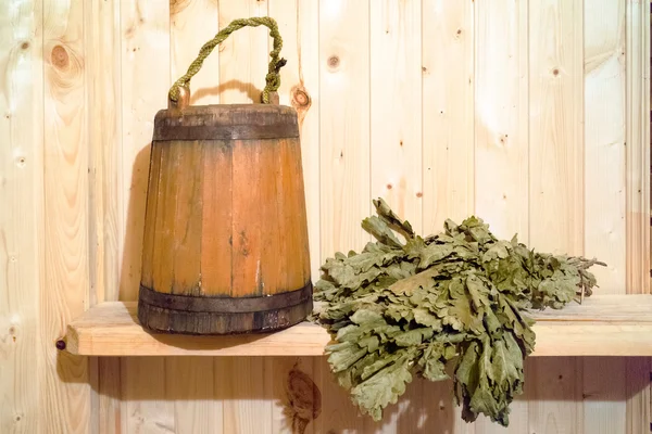 Russian sauna accessories: wooden busket and oak bloom — Stock Photo, Image