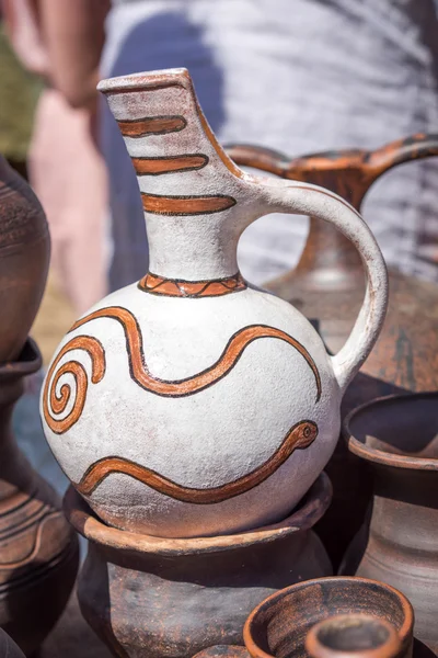 White and brown antique clay jug on the street market — Stock Photo, Image